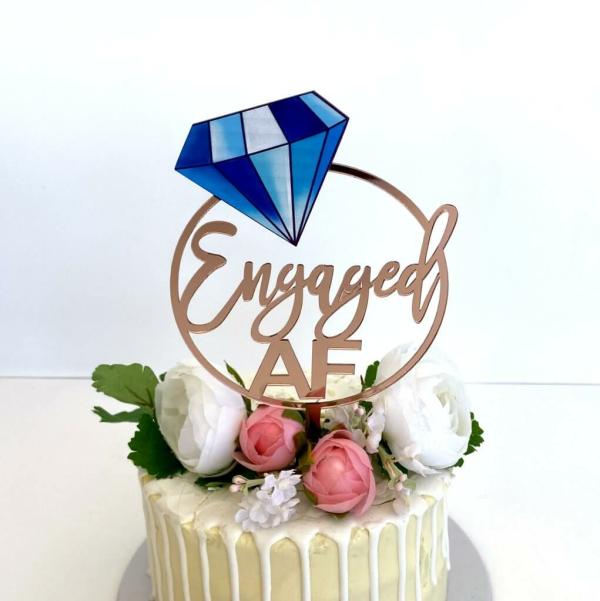 Acrylic Rose Gold ‘Engaged Af’ With Blue Diamond Cake Topper  |   Engagement