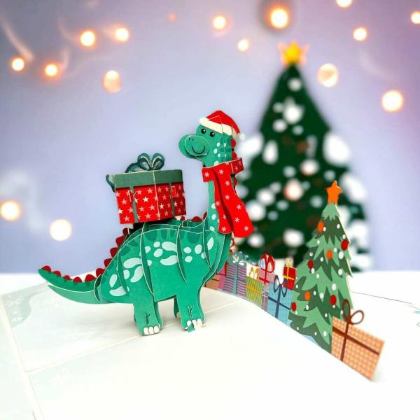 Green Baby Dinosaur With Christmas Present Pop Card  |   Christmas