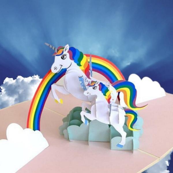 White Unicorn Mum And Baby Jumping Over Rainbow Card  |   Animals